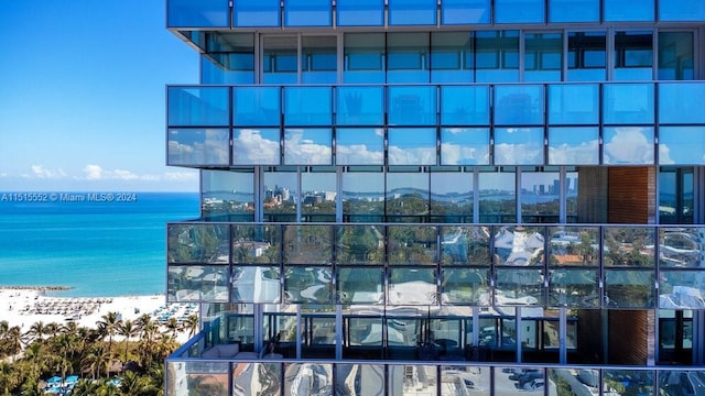 view of property featuring a water view and a view of the beach