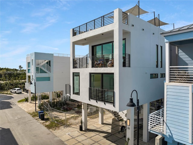 back of property featuring a balcony