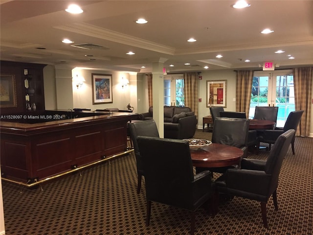 dining area with dark carpet, crown molding, and french doors