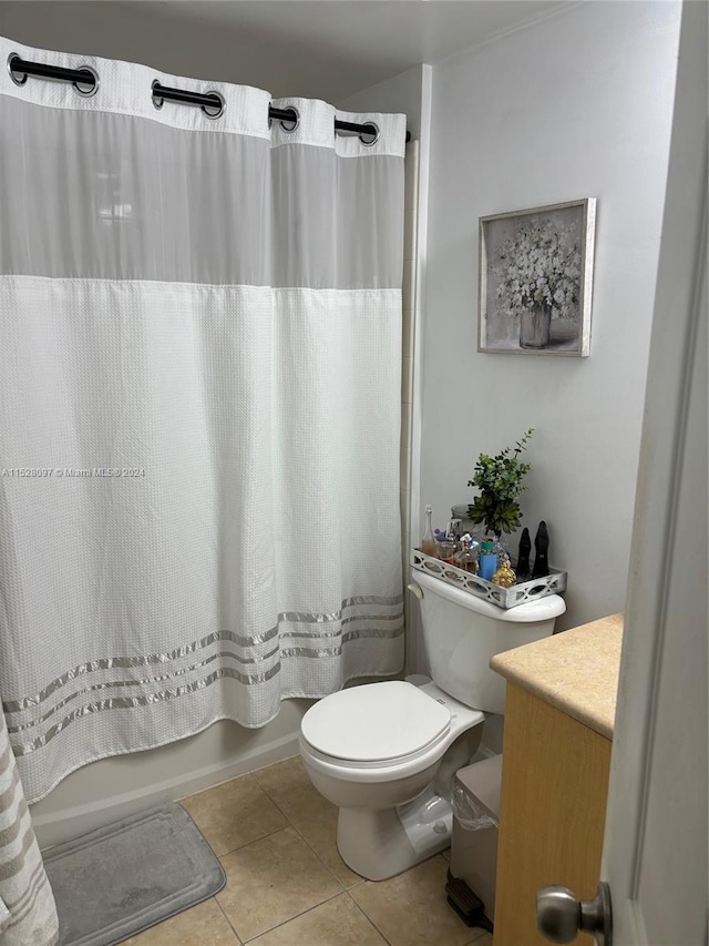 full bathroom featuring vanity, tile floors, shower / bath combo with shower curtain, and toilet