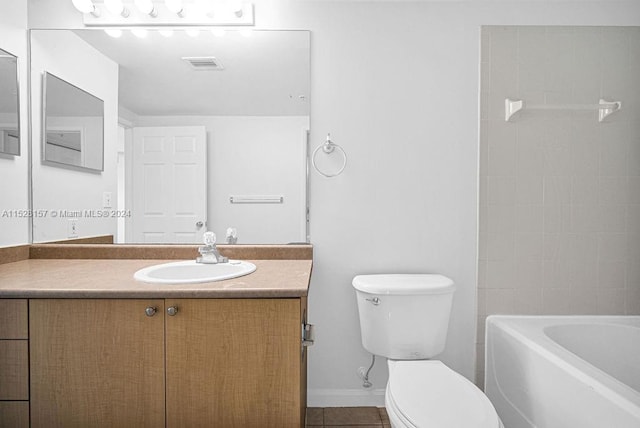 bathroom with tile patterned flooring, toilet, a washtub, and vanity