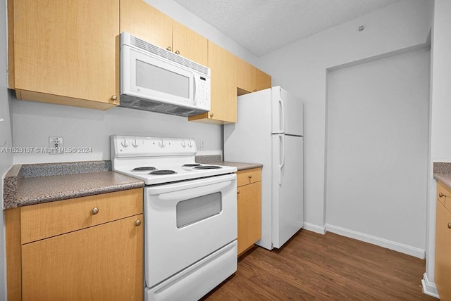 kitchen with dark wood-type flooring, white appliances, and a textured ceiling