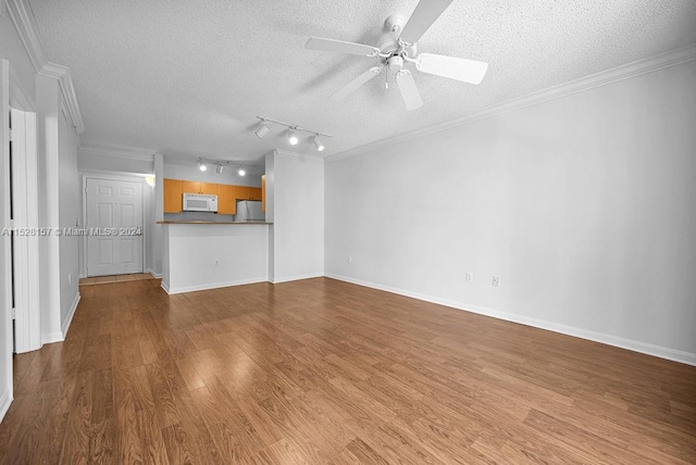 unfurnished living room with a textured ceiling, ceiling fan, ornamental molding, and wood-type flooring