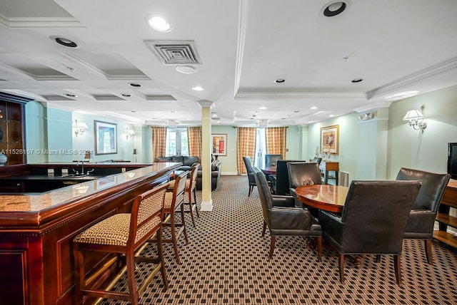 carpeted dining area featuring crown molding and ornate columns