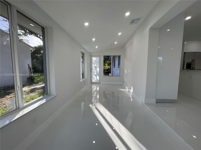 corridor featuring lofted ceiling