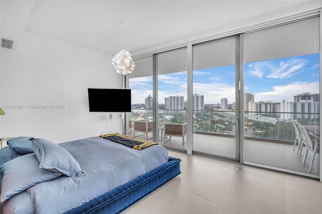 tiled bedroom with access to exterior and a wall of windows