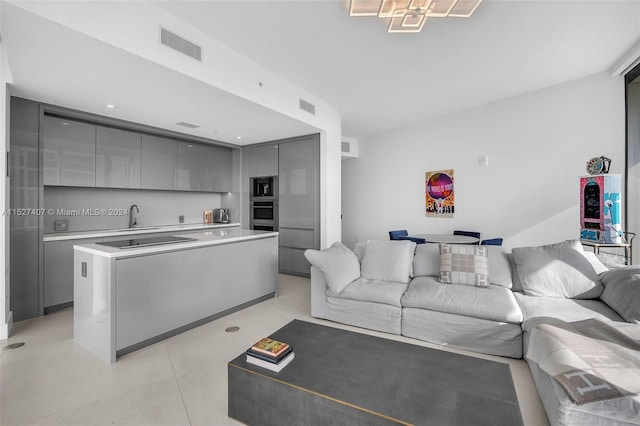 tiled living room featuring sink