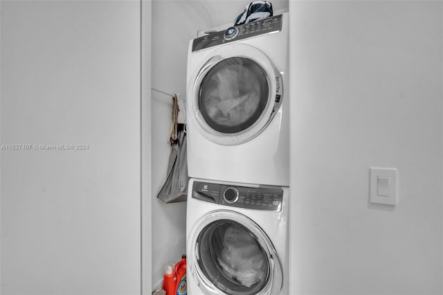 laundry area featuring stacked washing maching and dryer