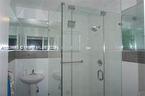 bathroom featuring an enclosed shower