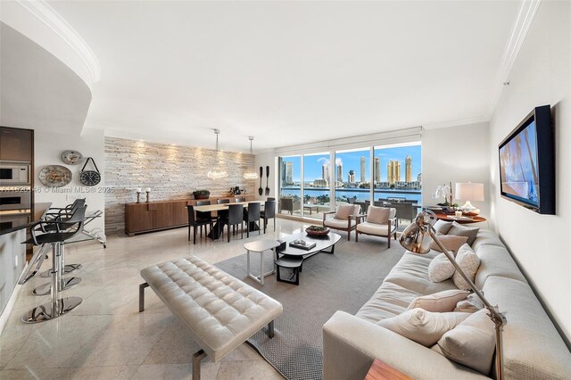 tiled living room featuring a raised ceiling and crown molding