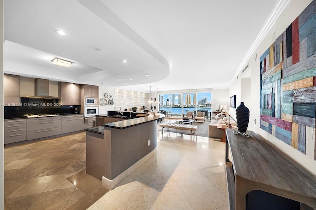 kitchen featuring backsplash, sink, light tile floors, wall chimney range hood, and white microwave