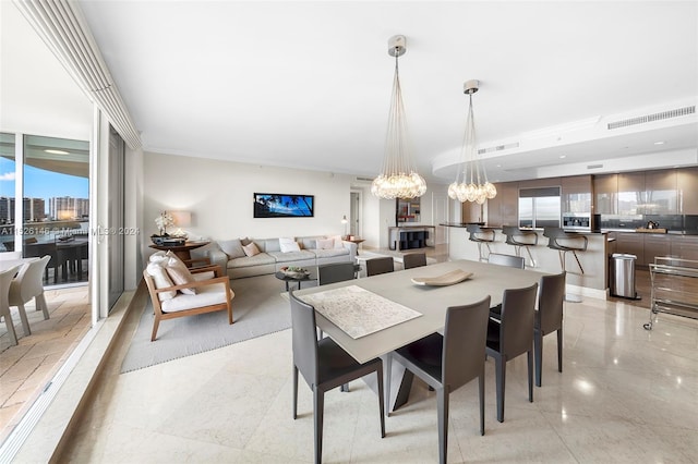 tiled dining space featuring an inviting chandelier and plenty of natural light