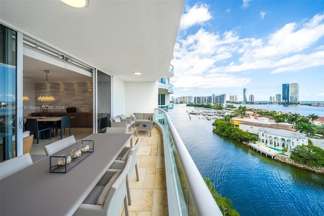 balcony featuring a water view and an outdoor living space