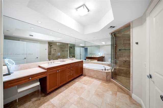 bathroom featuring double sink, tile flooring, a raised ceiling, separate shower and tub, and oversized vanity