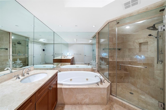 bathroom featuring independent shower and bath, tile floors, and vanity