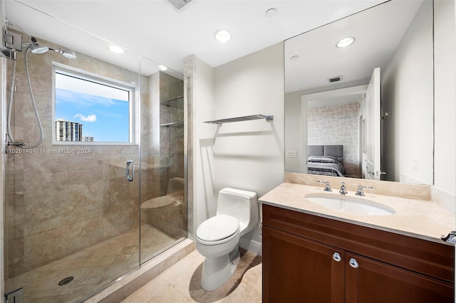 bathroom featuring toilet, vanity with extensive cabinet space, tile floors, and a shower with shower door