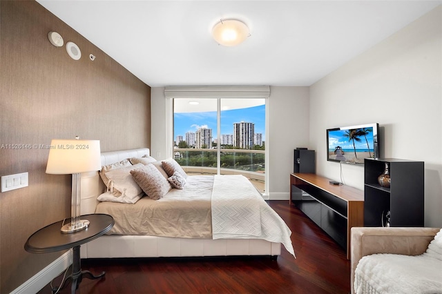 bedroom with dark hardwood / wood-style floors