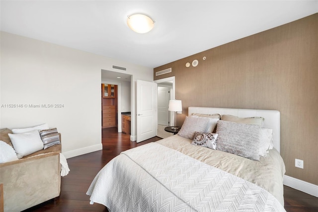 bedroom with dark wood-type flooring