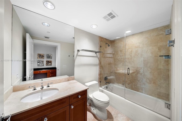 full bathroom featuring shower / bath combination with glass door, toilet, vanity, and tile flooring