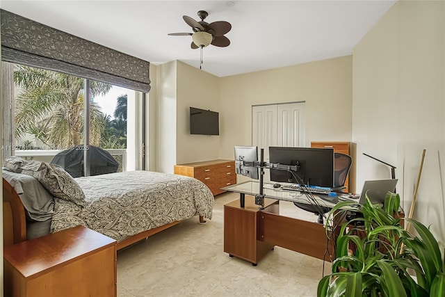 bedroom with ceiling fan and a closet