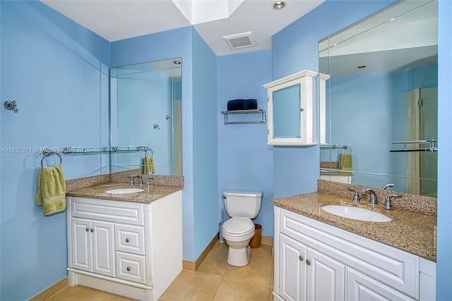 bathroom featuring vanity, toilet, and tile patterned flooring