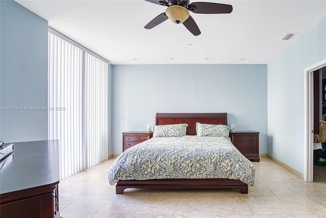 tiled bedroom featuring ceiling fan