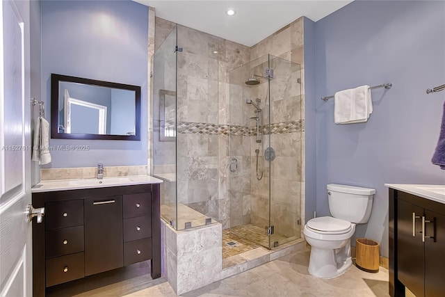 bathroom with vanity, toilet, and walk in shower