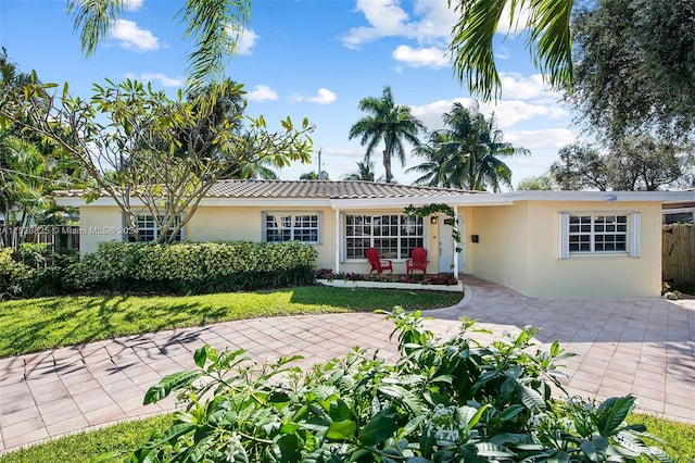 ranch-style house with a front lawn