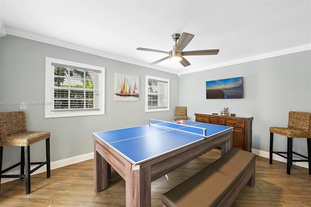 playroom with crown molding, ceiling fan, and light wood-type flooring