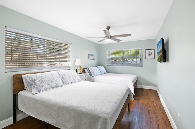 bedroom with ceiling fan and dark wood-type flooring