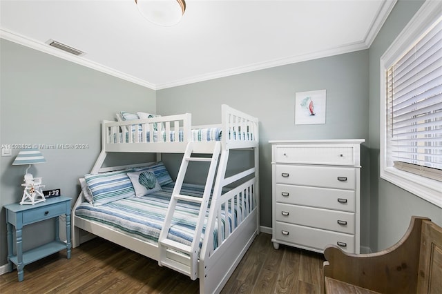 bedroom featuring crown molding and dark hardwood / wood-style floors