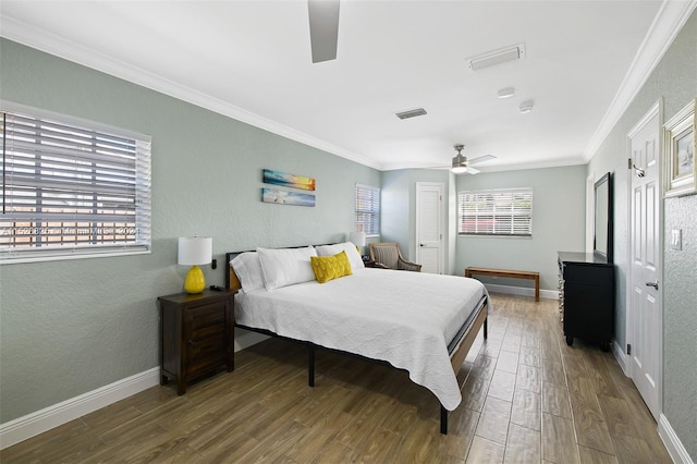 bedroom featuring hardwood / wood-style floors, ceiling fan, and ornamental molding