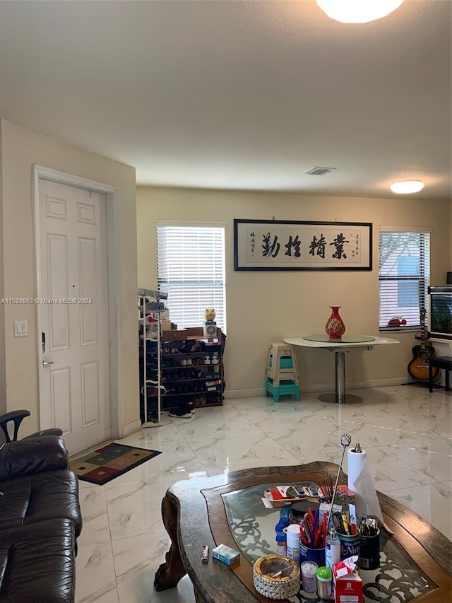 tiled living room with a healthy amount of sunlight