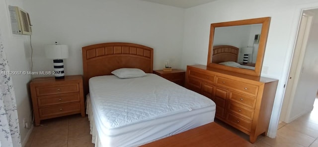 bedroom featuring light tile flooring and a wall mounted air conditioner