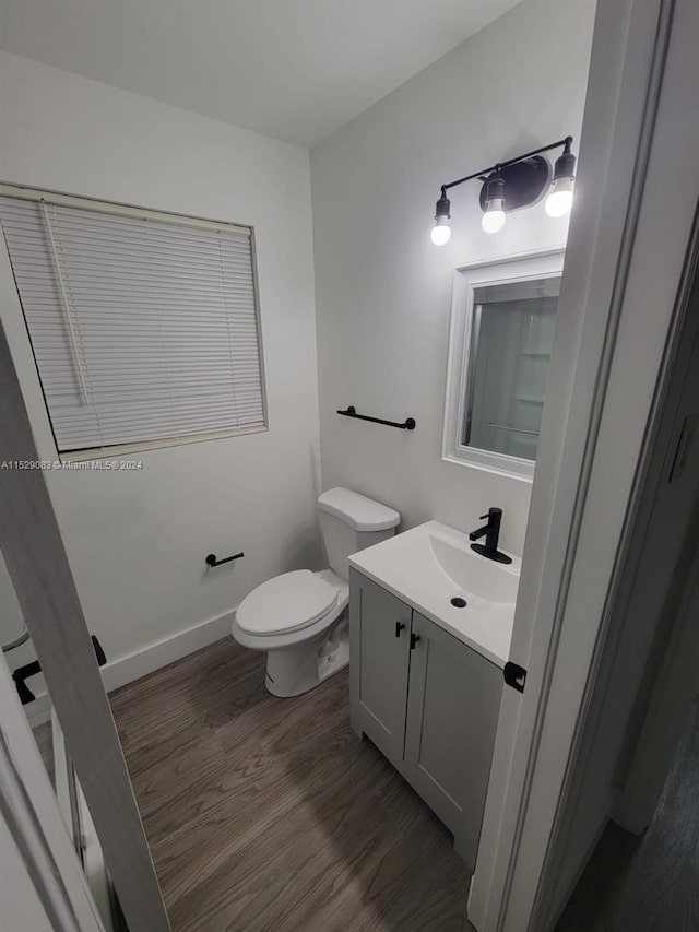 bathroom featuring hardwood / wood-style floors, vanity, and toilet