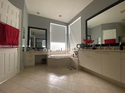 bathroom featuring vanity, tile flooring, and a bathing tub