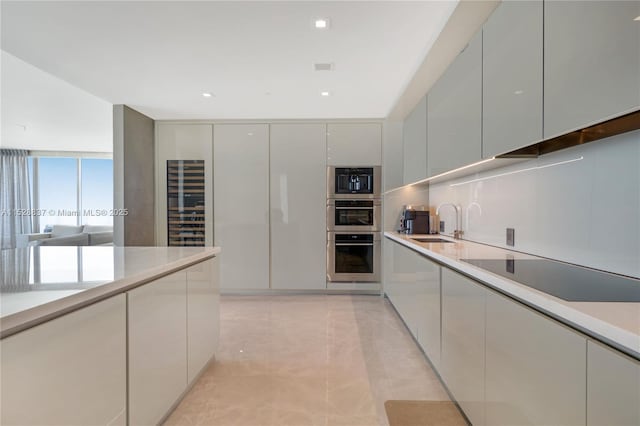 kitchen featuring white cabinetry, sink, black electric stovetop, and stainless steel double oven