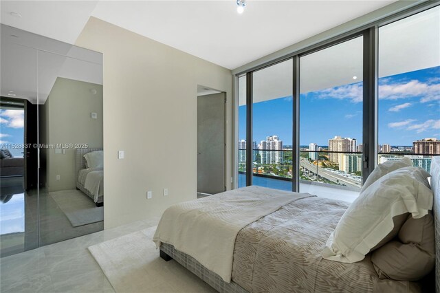 bedroom with expansive windows and access to outside