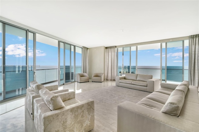 living room featuring a water view and a wall of windows