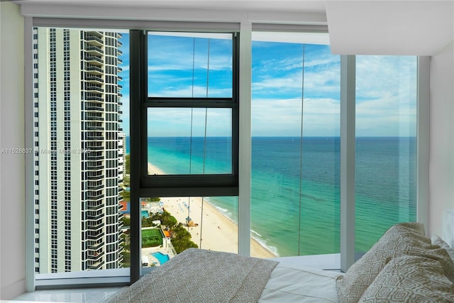 interior space with a view of the beach and a water view