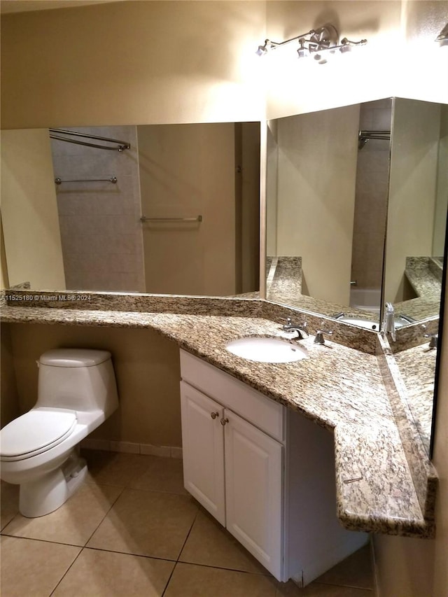 bathroom with toilet, tile floors, and vanity