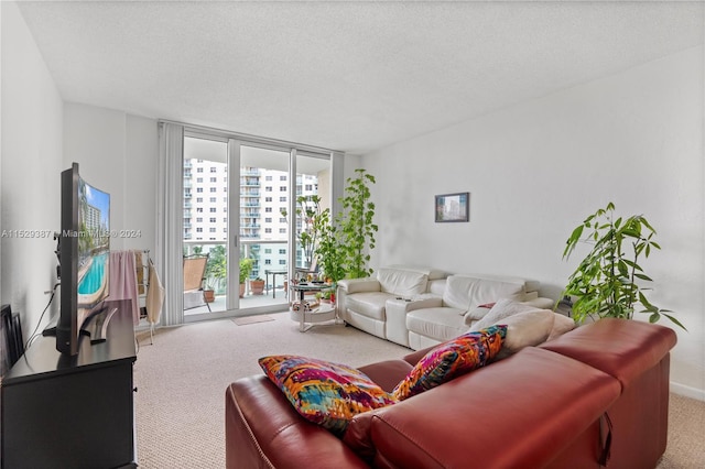 living room featuring light carpet, a wall of windows, and a textured ceiling