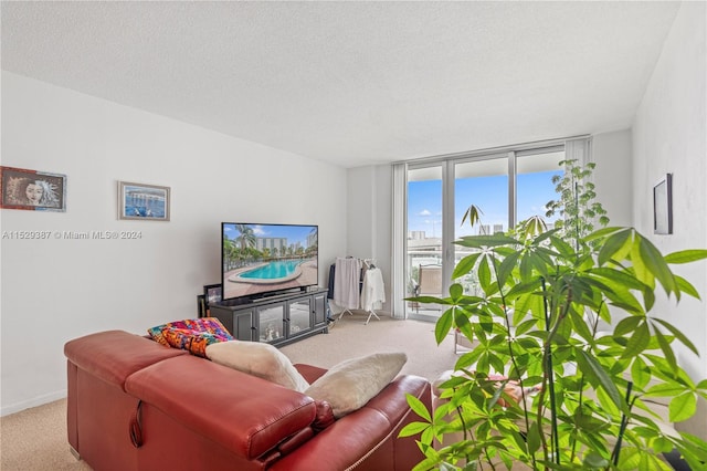 living room with light colored carpet, floor to ceiling windows, and a textured ceiling