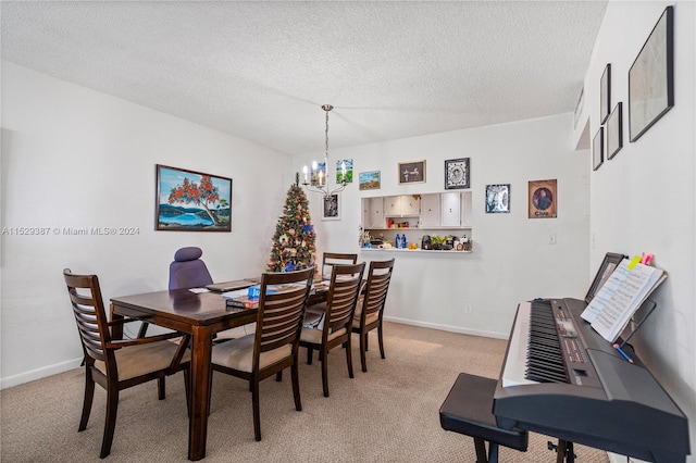 dining space featuring a textured ceiling, light colored carpet, and a chandelier