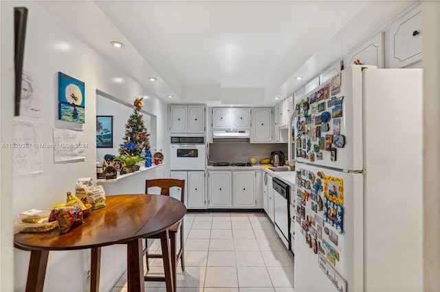 kitchen with white appliances and light tile floors