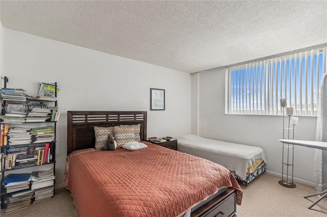 carpeted bedroom featuring a textured ceiling