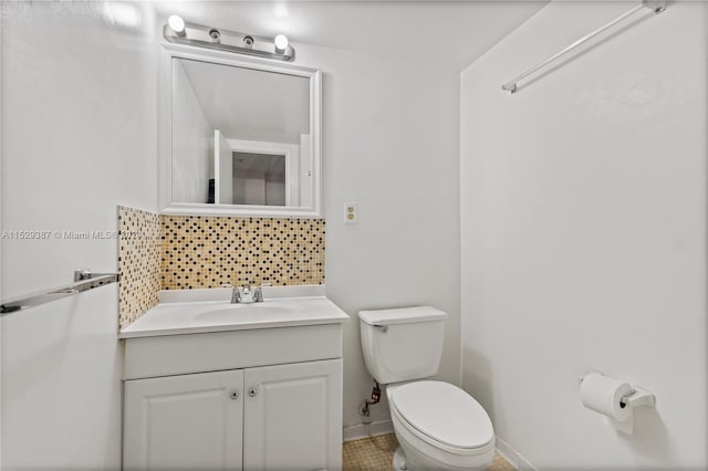 bathroom featuring toilet, tasteful backsplash, tile floors, and vanity