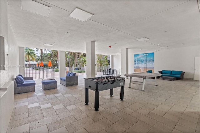 game room with floor to ceiling windows and light tile flooring