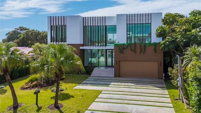 view of front of house with a balcony and a front yard