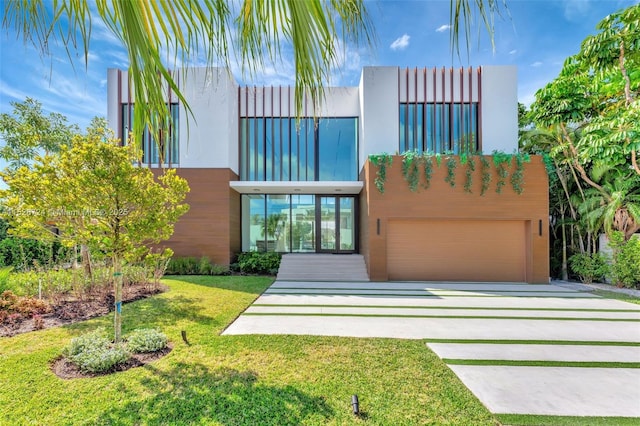 modern home with a front yard and a garage